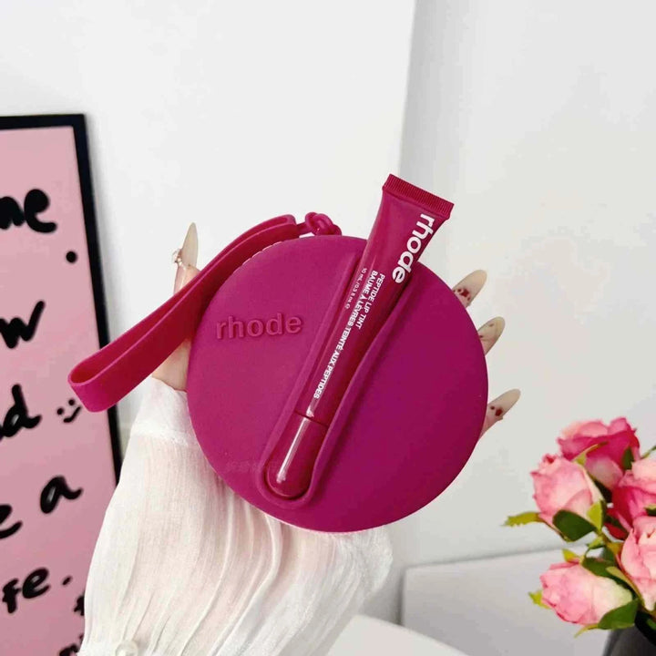 Rhode Peptide Lip Tint in sleek pink silicone case with wrist strap for on-the-go elegance and hydration