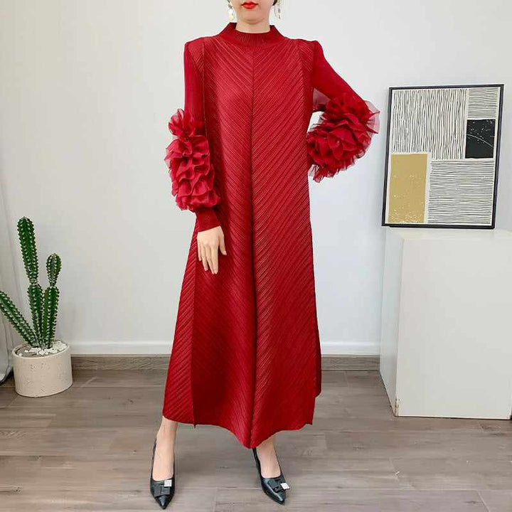 Women's long loose red dress with floral decorated sleeves.