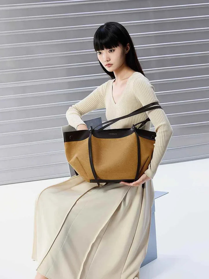 CHARLES & KEITH large two-tone tote bag with small inner pouch, worn by woman in beige outfit, modern and practical design