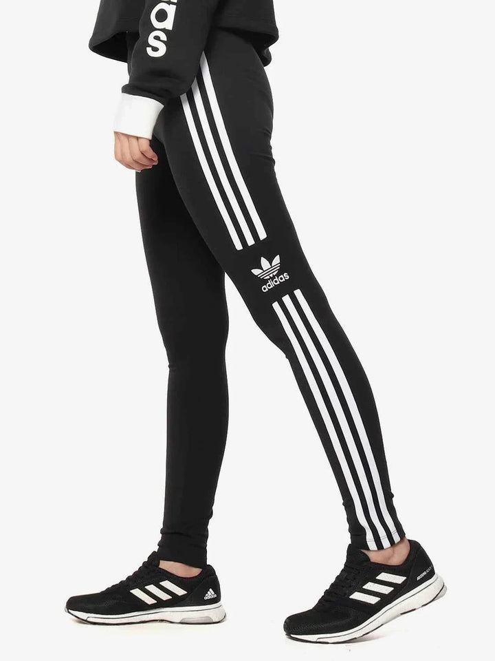 Black Adidas leggings with classic three white stripes on the side and Adidas logo, designed for comfort and activewear.