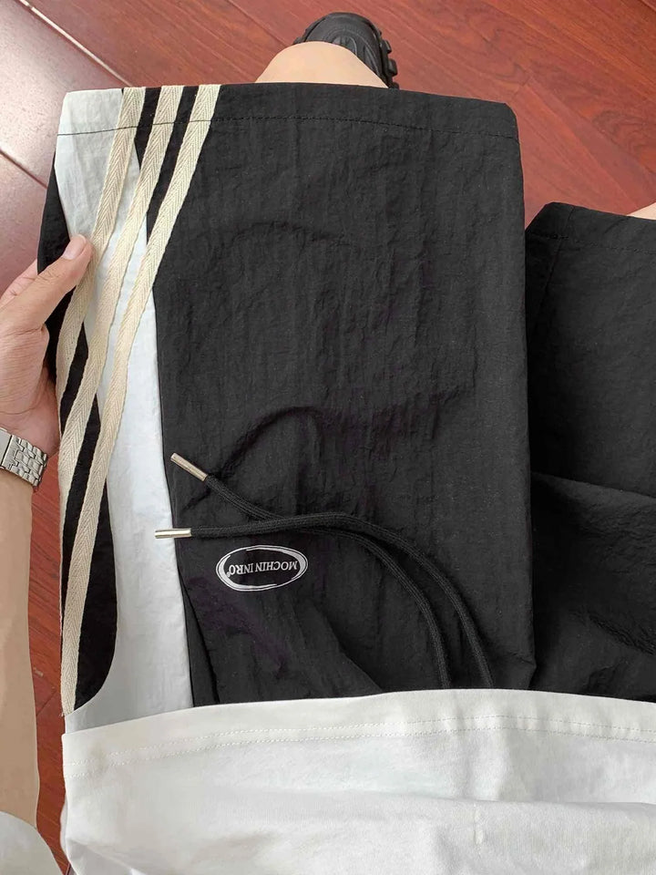 black sports shorts with beige side stripes and adjustable waistband in ice silk fabric