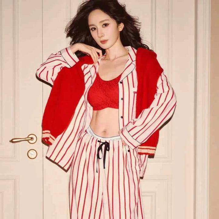 Woman wearing Victoria's Secret star staycation red and white striped Tencel soft print long sleeve pajama trousers and matching top with red bralette