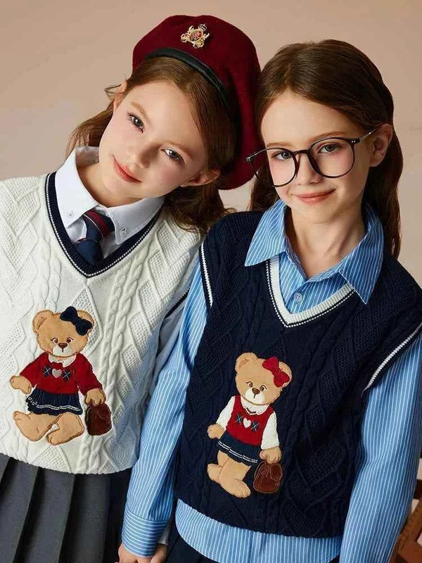 Two girls wearing PawinPaw Cartoon Bear woolen vests in autumn winter college style with V-neck and cotton layering.
