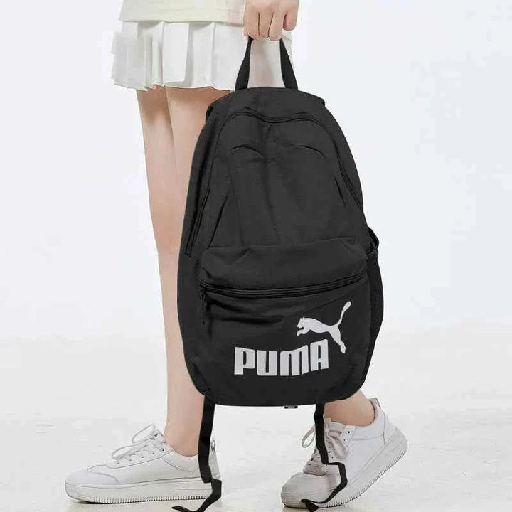 Black PUMA backpack with adjustable padded straps, front zip pocket, and durable lightweight material for school and daily use