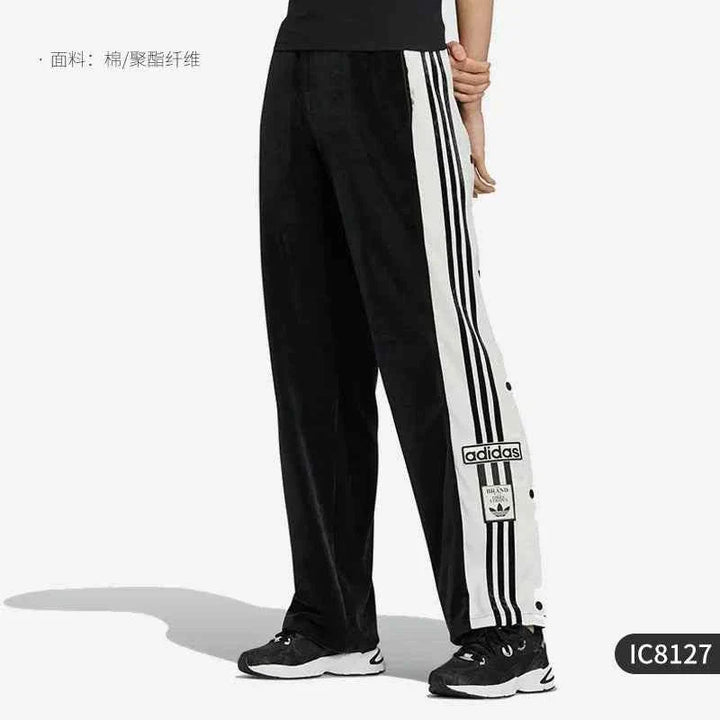 Black Adidas classic sports pants with white side stripes and side buttons