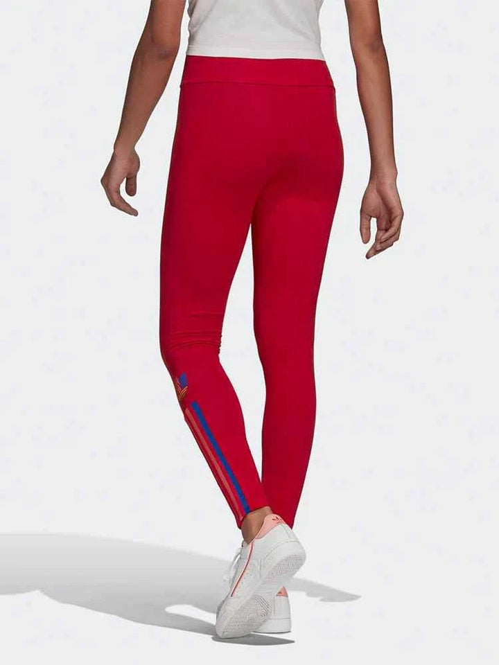 Red Adidas leggings with colorful side stripes and a slim fit for flexible movement and casual sporty style