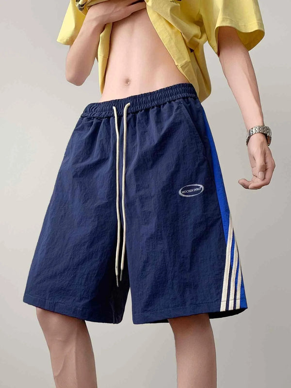 Blue athletic shorts with beige side stripes and adjustable waistband for casual and sportswear