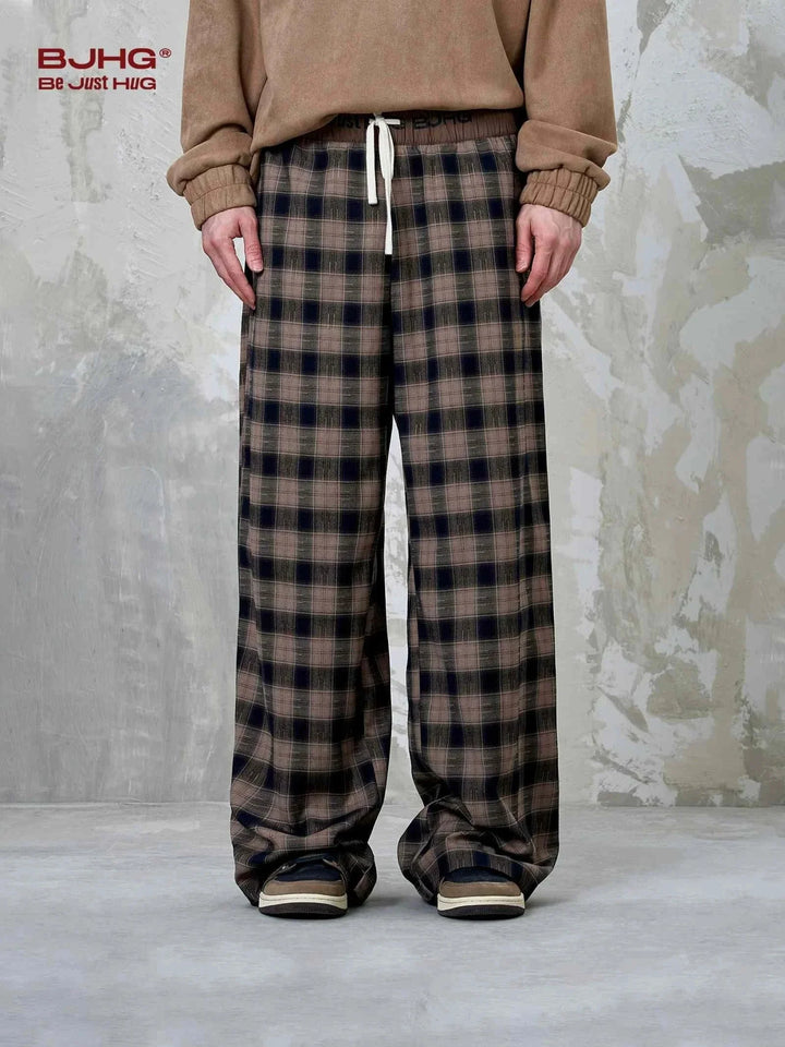 Wide checkered pants in brown and black tones with a relaxed fit and drawstring waist for casual comfort
