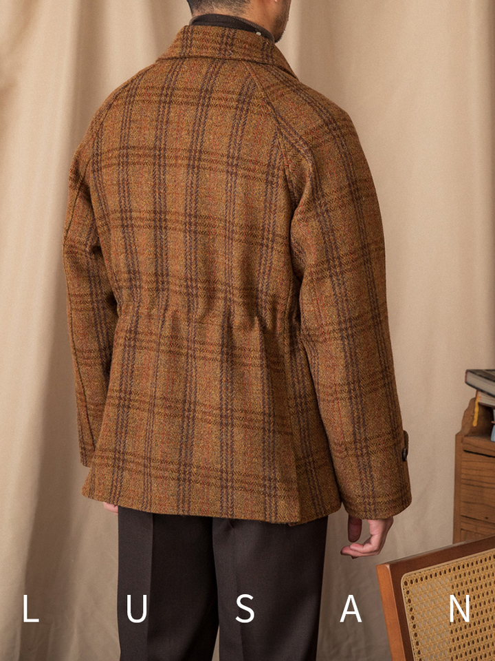 Mr. Lusan hunting tweed jacket in warm brown and orange plaid wool with adjustable cuffs and back detail