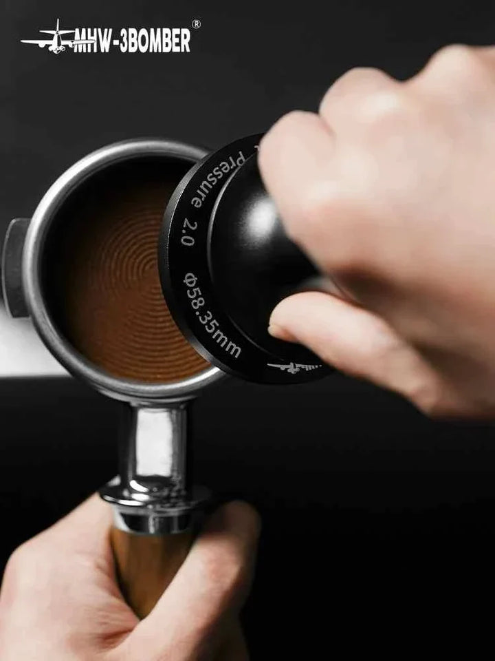 MHW-3BOMBER Espresso Coffee Tamper 2.0 with 58.35mm stainless steel base used to press coffee grounds in portafilter for espresso brewing.