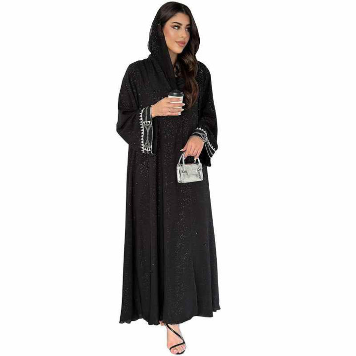 Elegant black abaya with traditional embroidery and subtle sparkle, featuring a hood design, available in three colors.