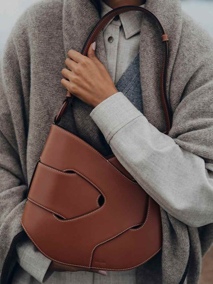 Polène Nodde Hobo bag in cognac full grain smooth cowhide leather with adjustable shoulder strap and contemporary geometric design