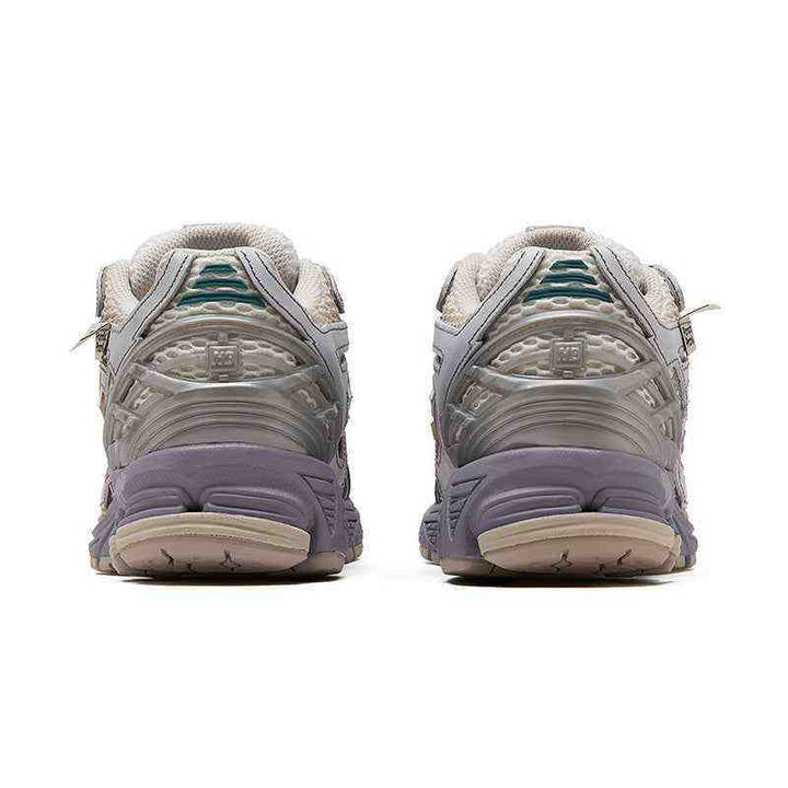 Rear view of New Balance NB 1906R limited edition sneakers in purple, beige, and gray with N-ergy sole technology.
