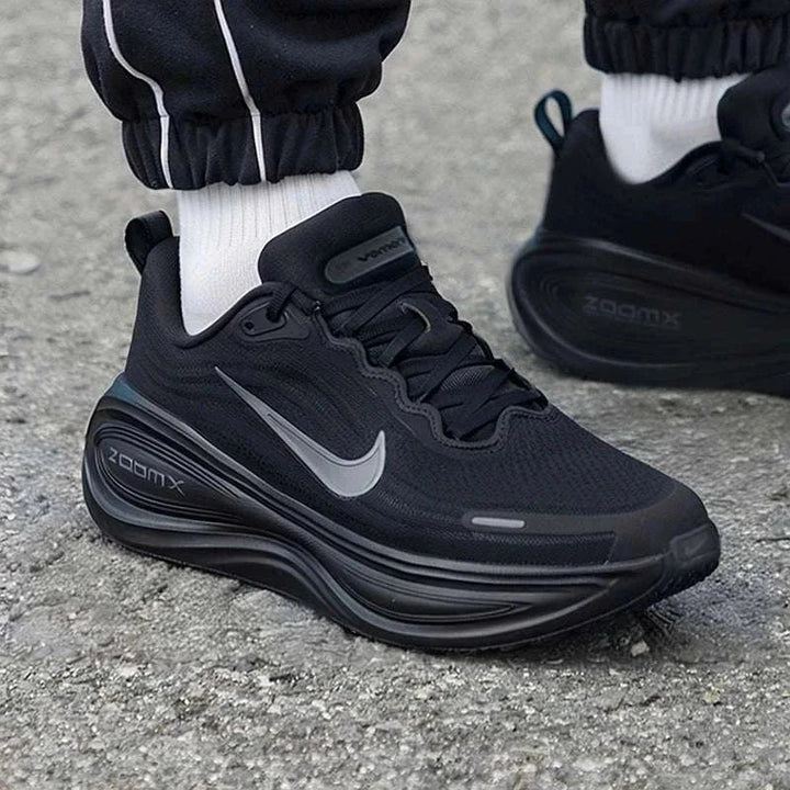 Nike Vomero Plus black running shoe with gray swoosh and ZoomX sole for city and athletic use