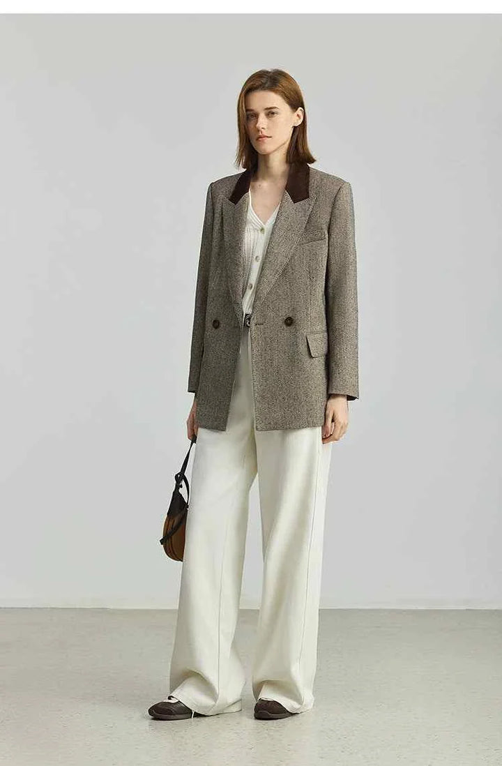 Woman wearing Elite suit LILY2025 autumn retro corduroy high-end commuter suit jacket with white wide-leg pants and brown shoes.