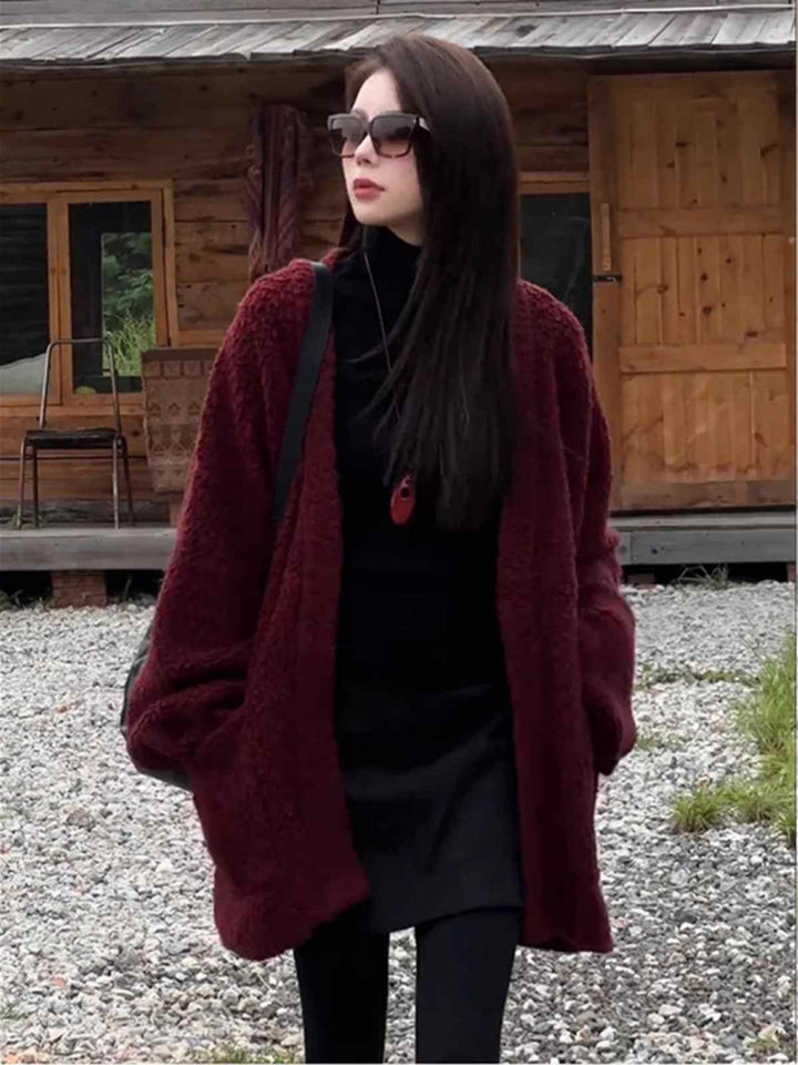 Long burgundy winter cardigan with wide sleeves and side pockets, cozy and elegant knitwear for cold weather.