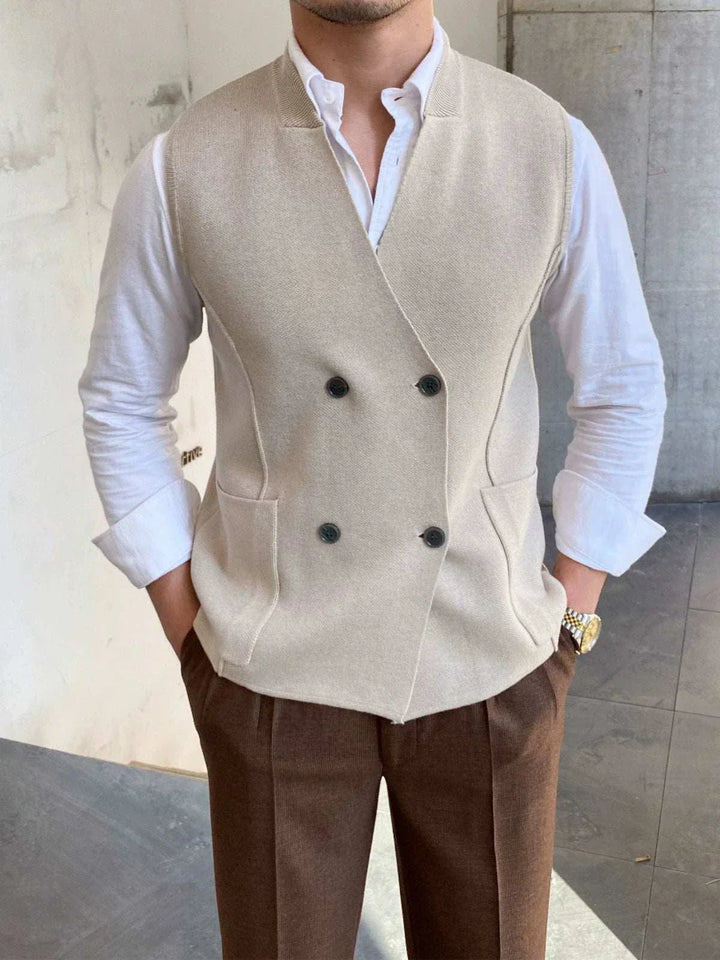 Mr. Lusan's British slim fit wool vest in beige with double buttons and side pockets worn over white shirt and brown trousers