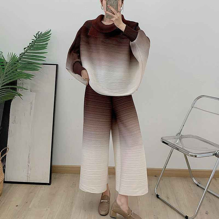 Pleated gradient suit 2025 spring with high-neck blouse and wide pants in soft colors.