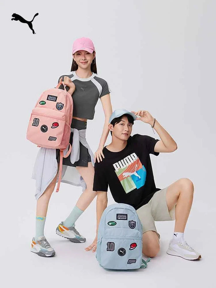 PUMA backpacks in pink and light blue with sporty patch designs, worn by young models showcasing casual and active styles.
