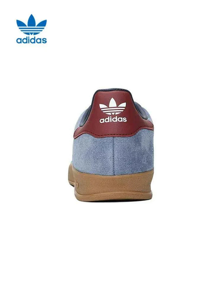 Back view of adidas أديداس سنيكرز جازيل إندور blue suede sneaker with brown heel tab and white adidas logo