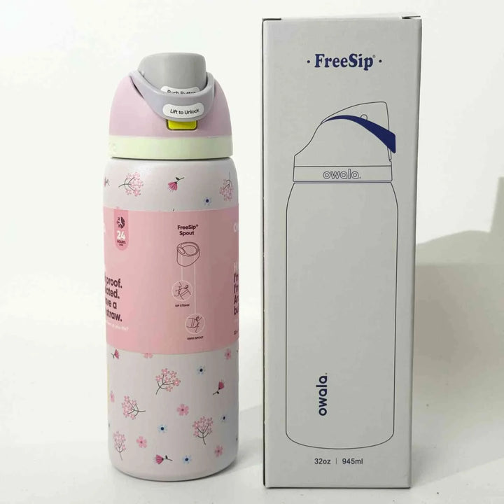 Pink Owala FreeSip stainless steel water bottle with floral design and leak-proof dual spout, shown with its white packaging box.