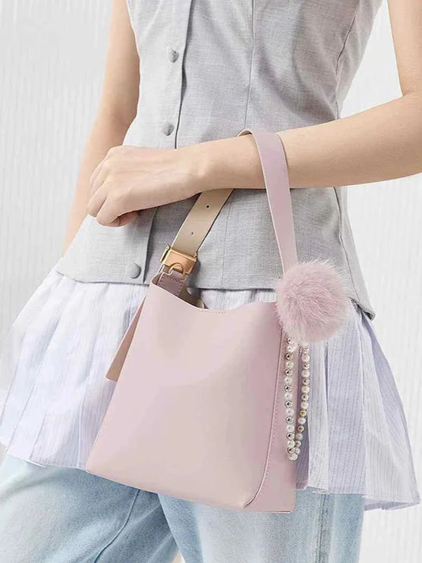 Small pink shoulder bag with faux fur pompom and pearl detail by CHARLES & KEITH