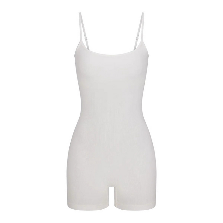 White SKIMS short romper with thin straps, soft stretch fabric, and a simple, fitted design.