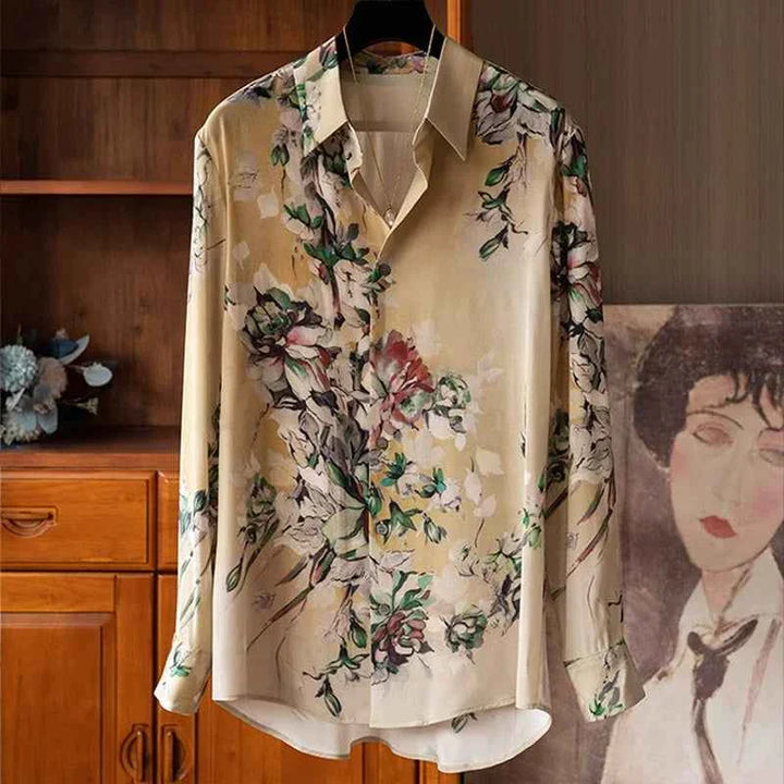 Classic floral silk shirt with pastel hues on a hanger.