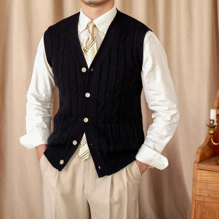 Mr. Lu San's wool cardigan vest black cable knit with pearl buttons and pockets on man in beige trousers and white shirt
