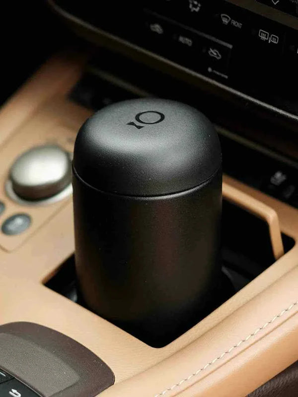 Fellow Carter travel mug in car cup holder, heat-retaining ceramic interior.