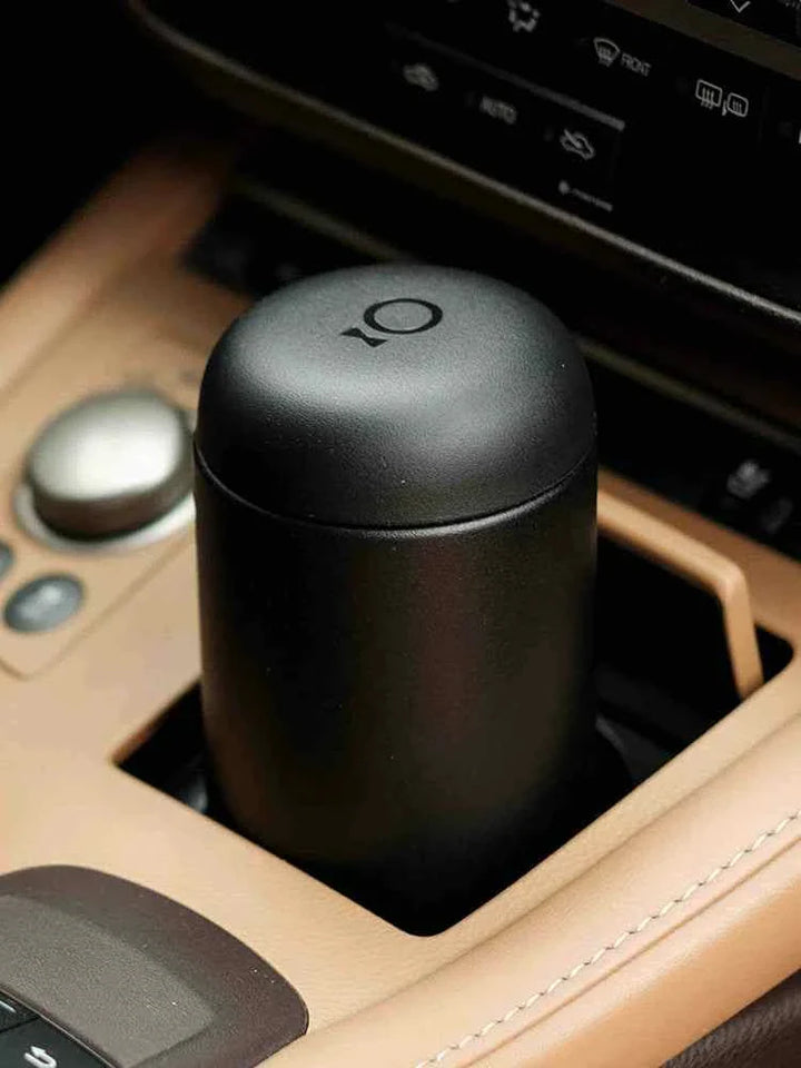 Fellow Carter travel mug in car cup holder, heat-retaining ceramic interior.