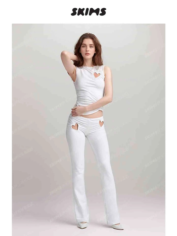 SKIMS Kardashian women's white fitted tank top and pants set with heart-shaped cutouts and high waist design.