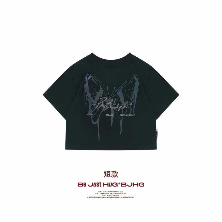 Black reflective butterfly print crop t-shirt with modern youthful design, comfortable fabric.