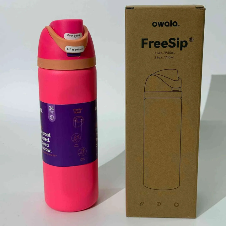Pink Owala Thermos Cup FreeSip stainless steel bottle with leak-proof lid and dual drinking spout next to cardboard packaging.