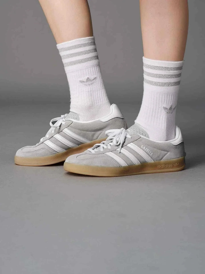Adidas GAZELLE INDOOR T-Toe classic suede sneakers in pastel gray with white stripes and gum sole worn with white socks