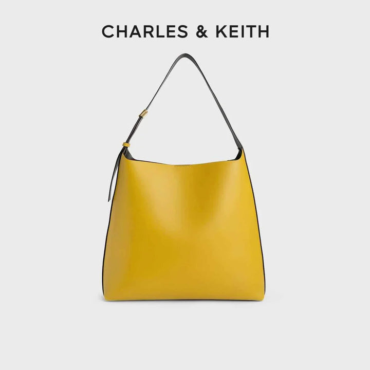 Yellow CHARLES & KEITH shoulder bag with wide adjustable strap and magnetic closure