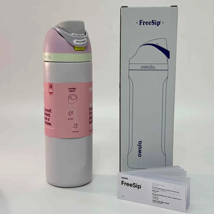 Pink and white Owala FreeSip stainless steel water bottle with dual spout and packaging box