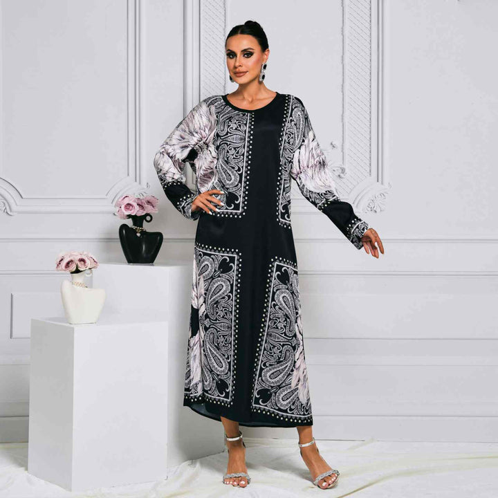 Elegant black sequin embroidered dress with sheer sleeves and flowing cape, perfect for formal occasions.