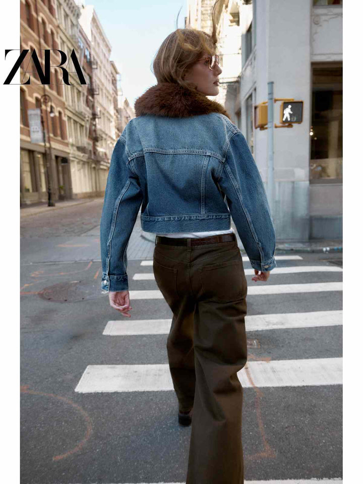 ZARA short denim jacket with brown fur collar worn by woman walking on city street