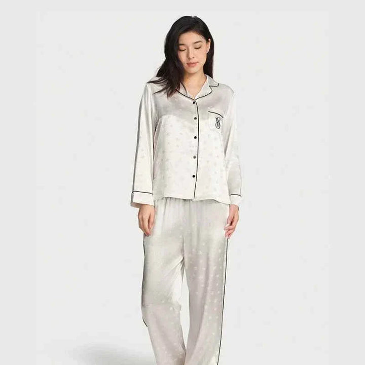woman wearing Victoria's Secret star staycation satin silk loungewear set with long sleeves and pants