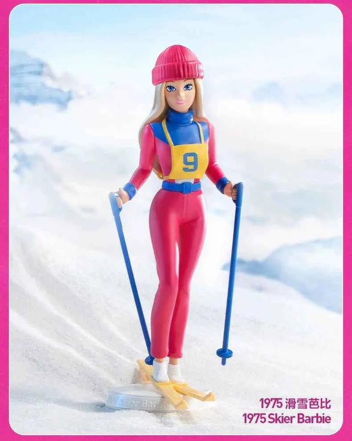 1975 Skier Barbie figure from the Barbie Fashion Series, wearing a pink and blue skiing outfit with ski poles, set against a snowy mountain backdrop.