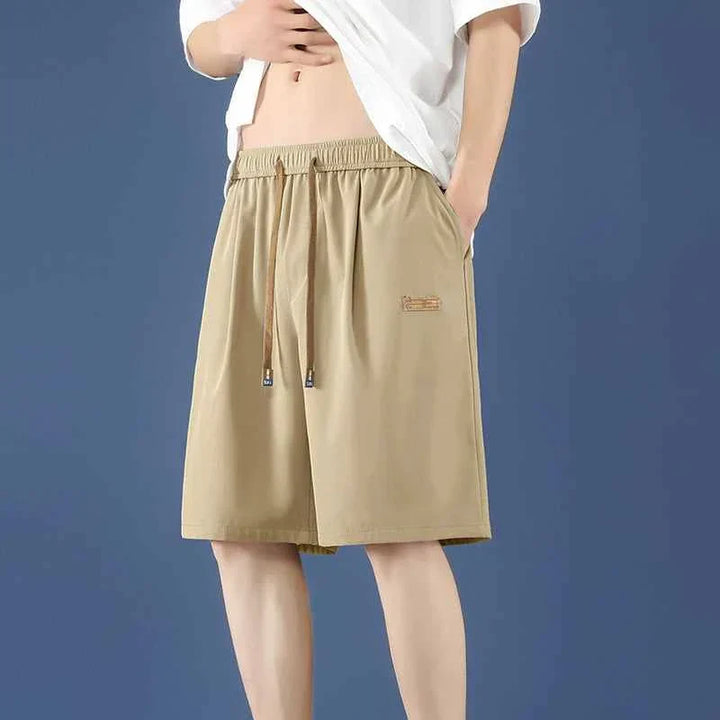 Beige men's Ice Silk shorts with adjustable waistband, loose fit, and lightweight fabric for summer comfort.