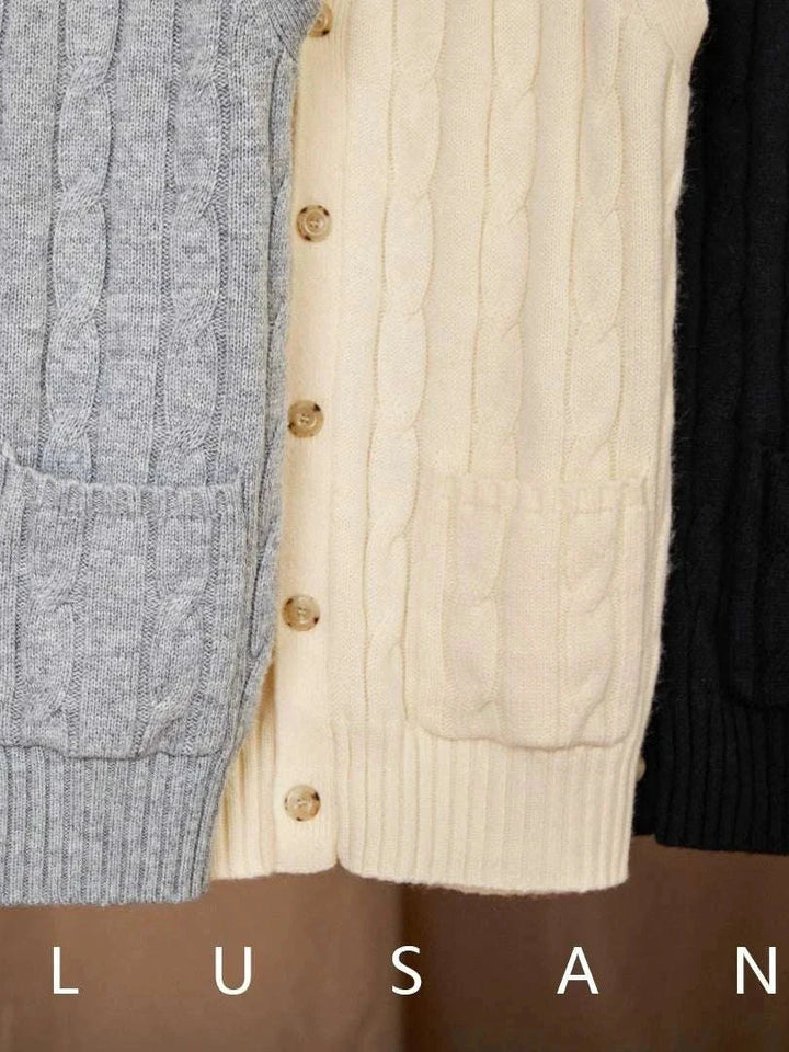 Mr. Lu San's wool cardigan vest in grey, cream, and black with cable knit design and pearl buttons