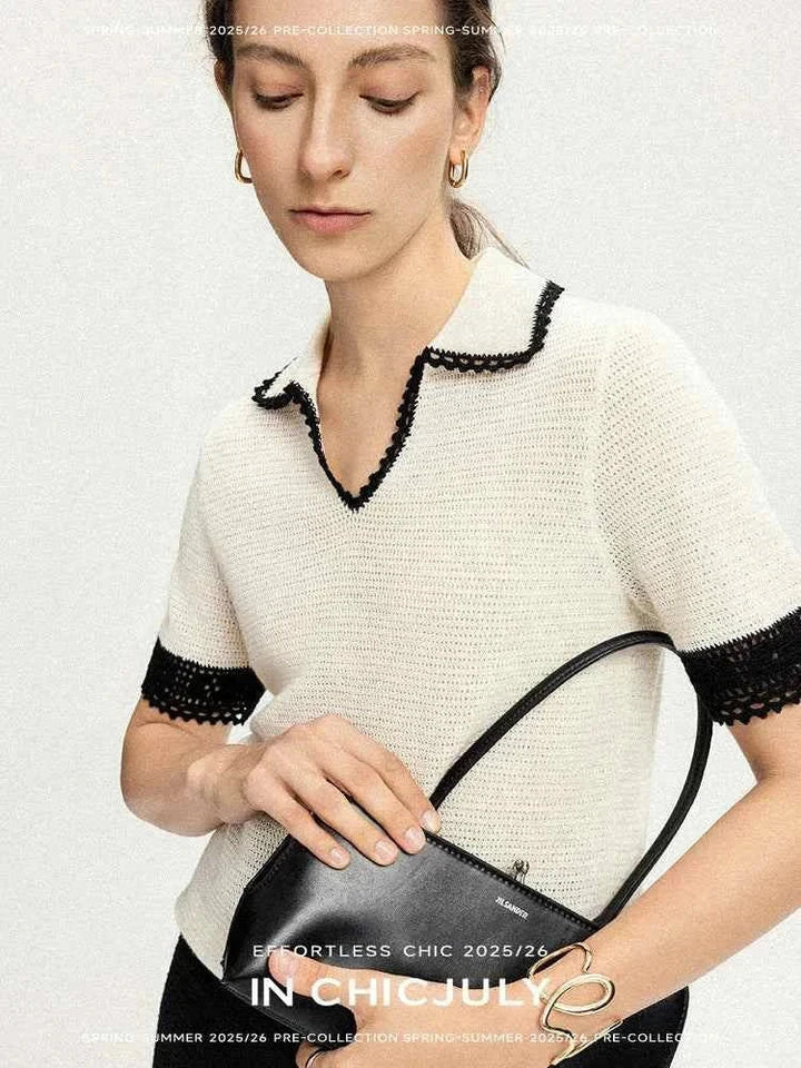 Woman wearing white CHICJULY blouse with black trim, holding black handbag, spring-summer 2025/26 collection