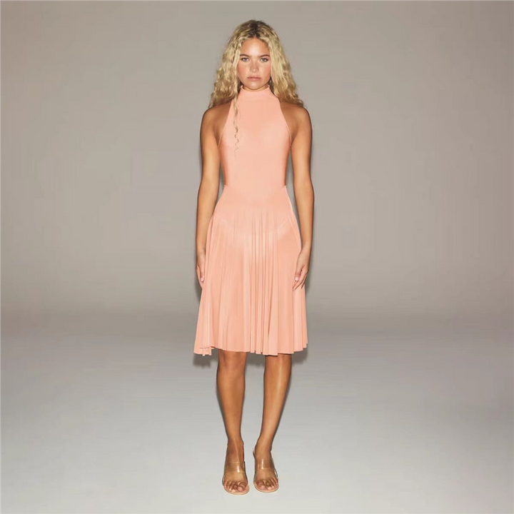 SKIMS high neck midi dress with sleeveless design and wide pleated skirt in soft peach color