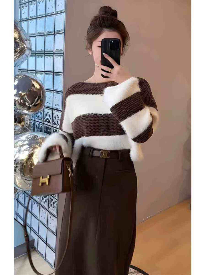 Elegant winter outfit featuring a striped brown and white cardigan paired with a high-waisted midi skirt and brown handbag.