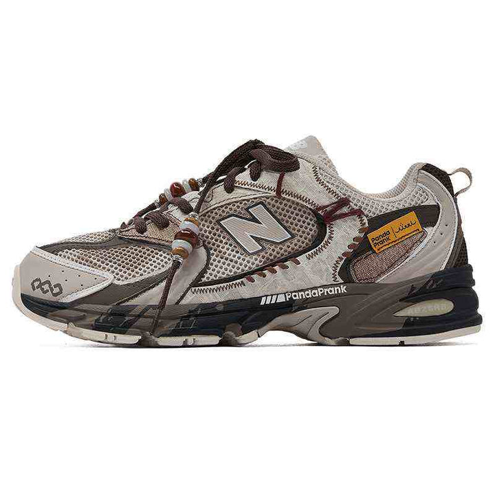New Balance إصدار مخصص sneaker in beige and brown with decorative beads, mesh and synthetic leather, cushioned sole, and PandaPrank logo detail