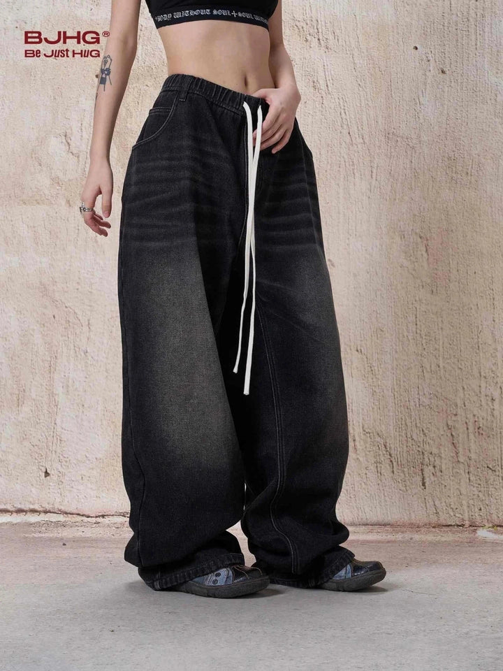 wide black denim jeans with white drawstring waistband for casual style
