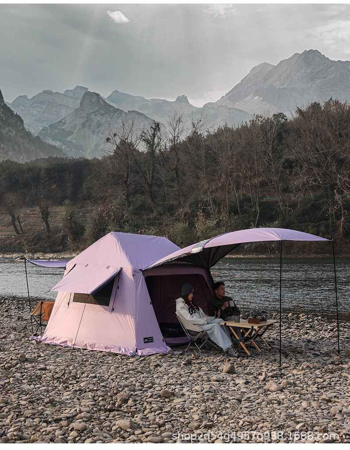 Outdoor Wolf Walker Cloud Pavilion inflatable camping tent with large canopy set up by riverside in mountainous wilderness