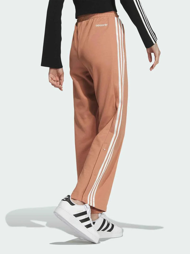 Adidas wide fit brown sports pants with classic white stripes and elastic waistband for comfort